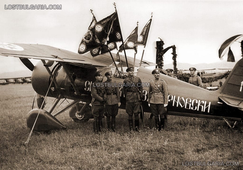 Български авиатори пред самолет PZL 24 B Ястреб, закичен с бойните знамена на полка